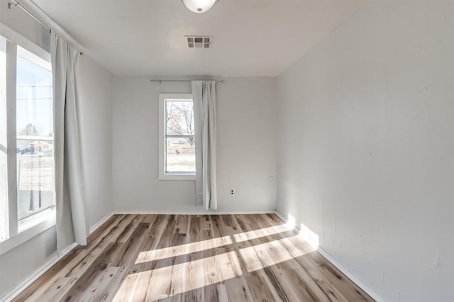empty room featuring wood finished floors and baseboards
