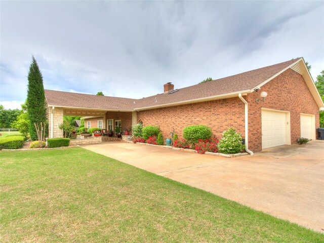 8501 S Council Rd, Oklahoma City, OK 73169 - ranch-style home featuring a garage, a chimney, a front lawn, concrete driveway, and brick siding