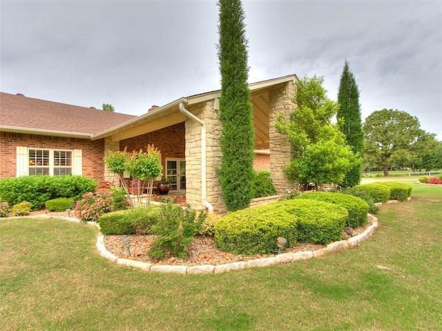 8501 S Council Rd, Oklahoma City, OK 73169 - view of side of home featuring a lawn, stone siding, and brick siding