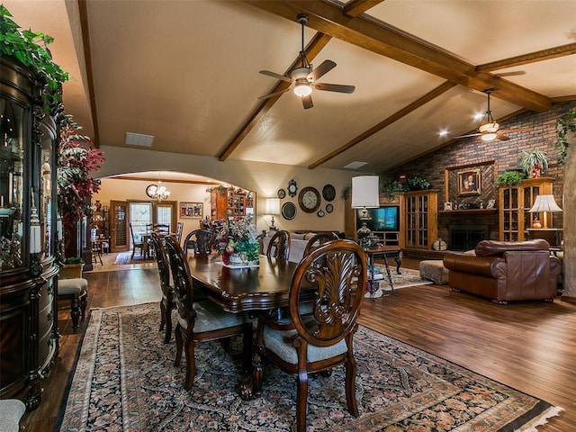8501 S Council Rd, Oklahoma City, OK 73169 - dining area featuring arched walkways, wood finished floors, ceiling fan, a brick fireplace, and brick wall