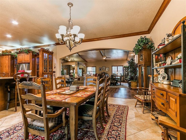 8501 S Council Rd, Oklahoma City, OK 73169 - dining area featuring arched walkways, a textured ceiling, a chandelier, ornamental molding, and ceiling fan