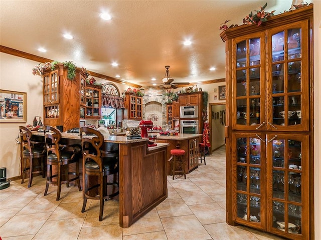 8501 S Council Rd, Oklahoma City, OK 73169 - indoor dry bar featuring oven, crown molding, a ceiling fan, light tile patterned floors, and recessed lighting