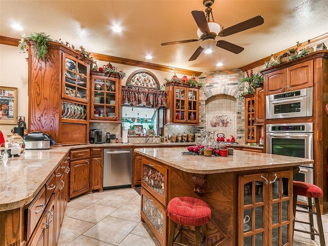 8501 S Council Rd, Oklahoma City, OK 73169 - kitchen with dishwasher, a breakfast bar, backsplash, glass insert cabinets, and a kitchen island