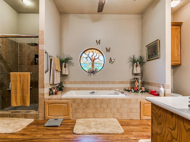 8501 S Council Rd, Oklahoma City, OK 73169 - bathroom with a bath, wood finished floors, a stall shower, and vanity