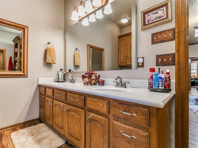 8501 S Council Rd, Oklahoma City, OK 73169 - full bath with wood finished floors, double vanity, baseboards, and a textured wall