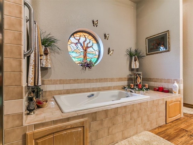 8501 S Council Rd, Oklahoma City, OK 73169 - bathroom featuring a garden tub, wood finished floors, and a textured wall