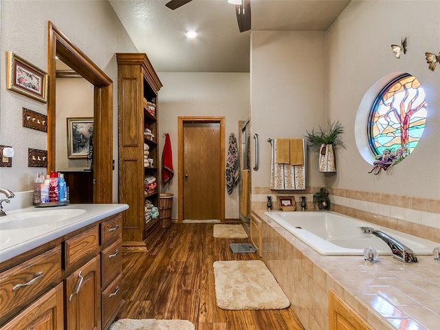 8501 S Council Rd, Oklahoma City, OK 73169 - bathroom featuring wood finished floors, a shower stall, a garden tub, ceiling fan, and vanity