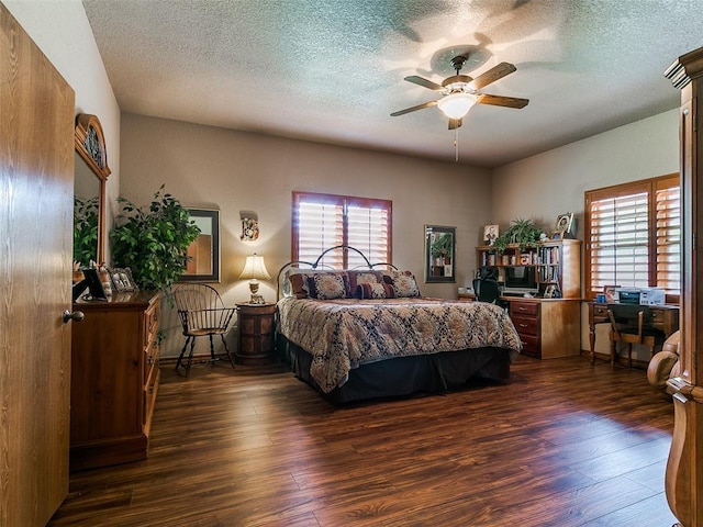 8501 S Council Rd, Oklahoma City, OK 73169 - bedroom with dark wood-style floors, multiple windows, a textured ceiling, and a ceiling fan