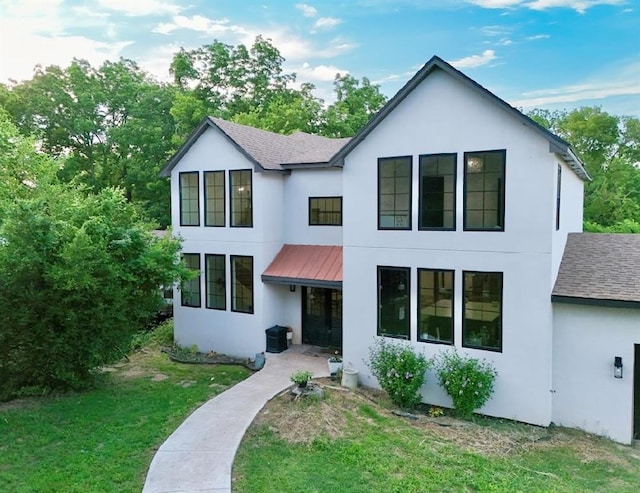 40202 Benson Park Rd, Shawnee, OK 74801 - view of front of home featuring stucco siding, a shingled roof, a front yard, and a metal roof