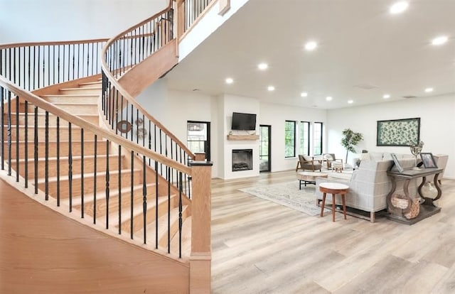 40202 Benson Park Rd, Shawnee, OK 74801 - living room featuring wood finished floors, recessed lighting, a fireplace, and stairway