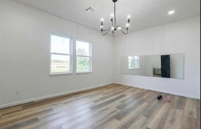 40202 Benson Park Rd, Shawnee, OK 74801 - spare room featuring a chandelier and wood finished floors