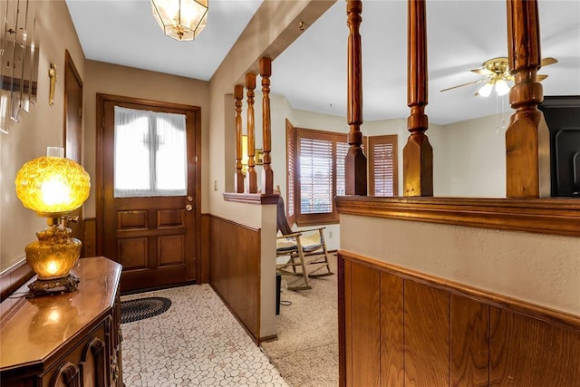 7108 S Kentucky St, Oklahoma City, OK 73159 - foyer entrance with healthy amount of natural light, wainscoting, a ceiling fan, and light carpet
