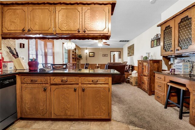 7108 S Kentucky St, Oklahoma City, OK 73159 - kitchen featuring stainless steel dishwasher, dark countertops, a peninsula, brown cabinetry, and a ceiling fan
