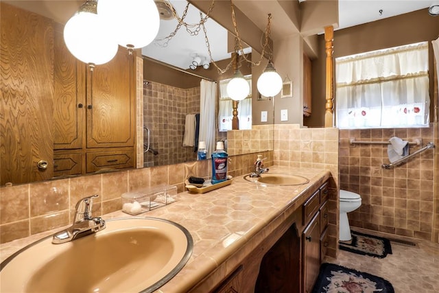 7108 S Kentucky St, Oklahoma City, OK 73159 - full bathroom with tile walls, toilet, double vanity, and a shower with shower curtain