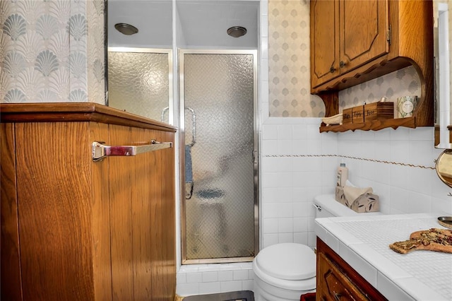 7108 S Kentucky St, Oklahoma City, OK 73159 - bathroom with wallpapered walls, toilet, a shower stall, a wainscoted wall, and vanity