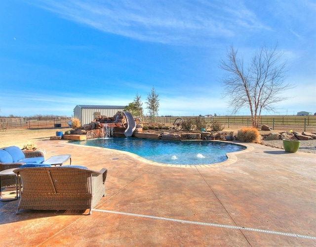 5400 N Piedmont Rd Unit A, Piedmont, OK 73078 - view of pool featuring a water slide, a fenced backyard, a patio, and an outdoor structure