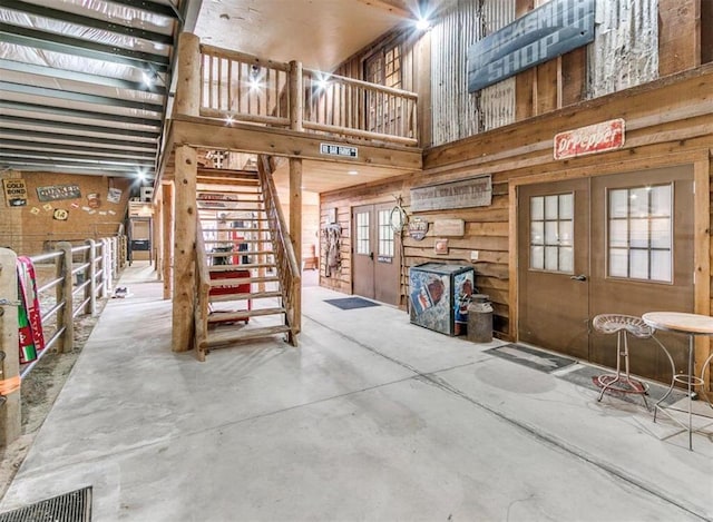 5400 N Piedmont Rd Unit A, Piedmont, OK 73078 - living area with a high ceiling, french doors, unfinished concrete floors, and stairway