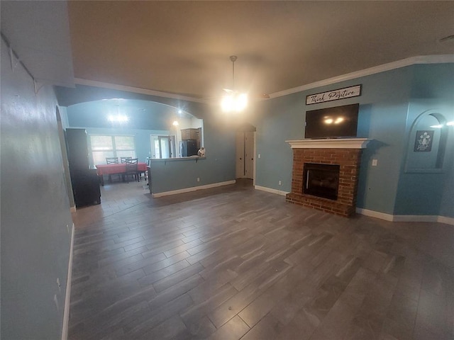 531 W Shadow Ridge Way, Mustang, OK 73064 - unfurnished living room with wood finished floors, ornamental molding, a fireplace, and baseboards
