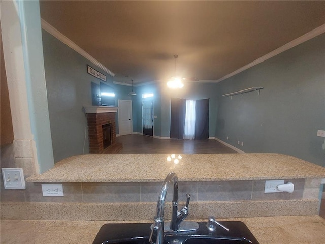 531 W Shadow Ridge Way, Mustang, OK 73064 - kitchen with crown molding, a brick fireplace, and a sink