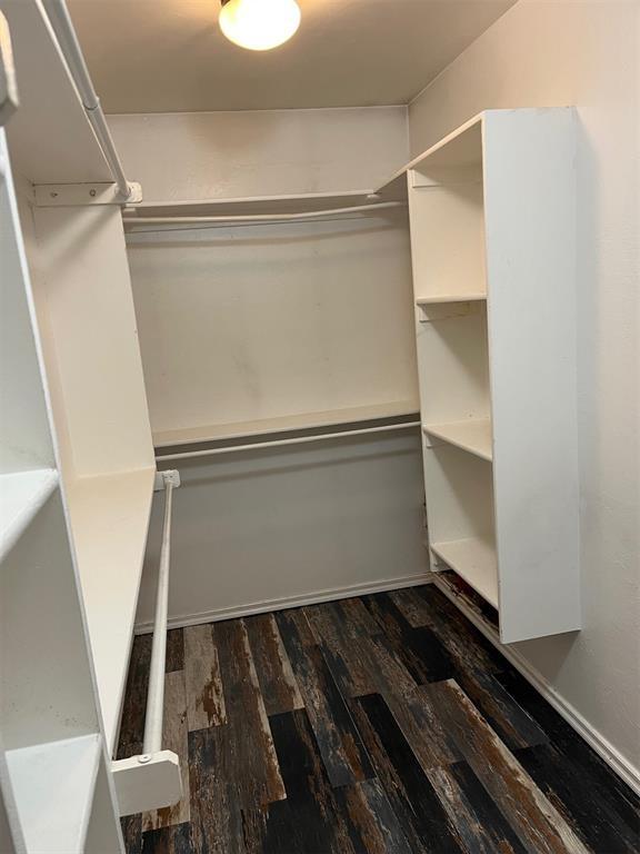 531 W Shadow Ridge Way, Mustang, OK 73064 - spacious closet with dark wood-style flooring