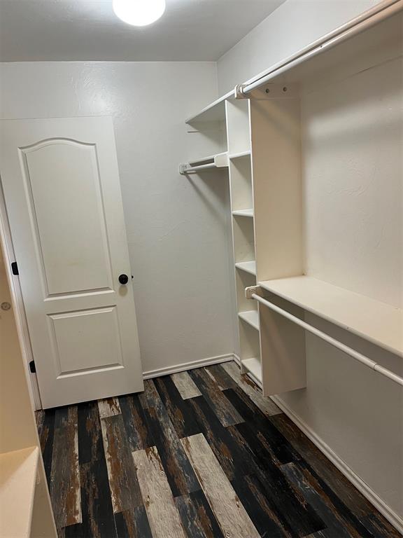 531 W Shadow Ridge Way, Mustang, OK 73064 - spacious closet with dark wood finished floors
