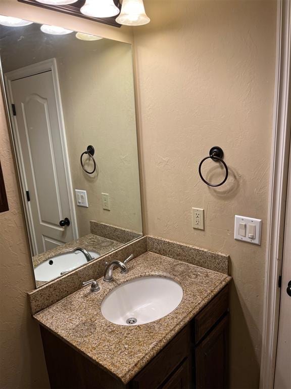 531 W Shadow Ridge Way, Mustang, OK 73064 - bathroom featuring vanity and a textured wall