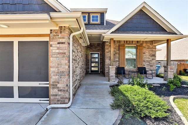 3024 Drake Crest Dr, Edmond, OK 73034 - doorway to property with a porch, brick siding, and a garage