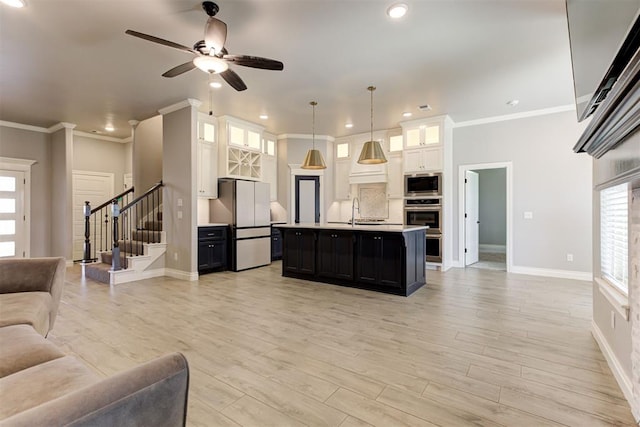 3024 Drake Crest Dr, Edmond, OK 73034 - living room with baseboards, stairs, a ceiling fan, ornamental molding, and recessed lighting