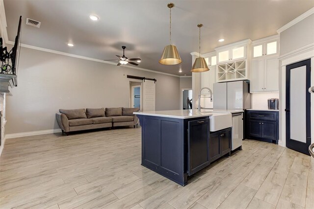 3024 Drake Crest Dr, Edmond, OK 73034 - kitchen featuring a barn door, light countertops, a sink, dishwasher, and a ceiling fan