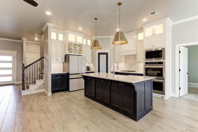 3024 Drake Crest Dr, Edmond, OK 73034 - kitchen with freestanding refrigerator, built in microwave, double oven, light countertops, and ornamental molding