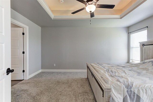 3024 Drake Crest Dr, Edmond, OK 73034 - bedroom featuring a tray ceiling, light carpet, baseboards, ceiling fan, and ornamental molding
