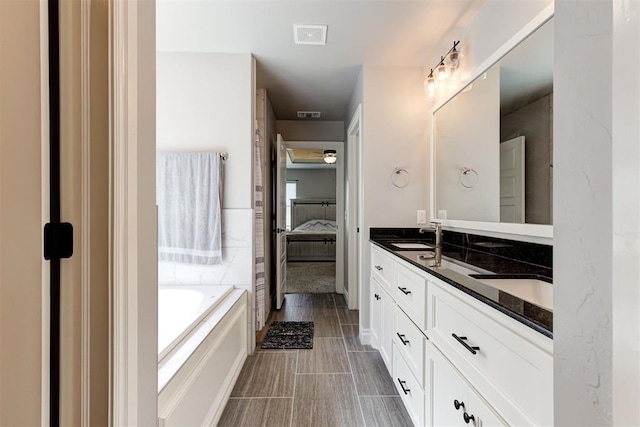 3024 Drake Crest Dr, Edmond, OK 73034 - ensuite bathroom with a bath and double vanity