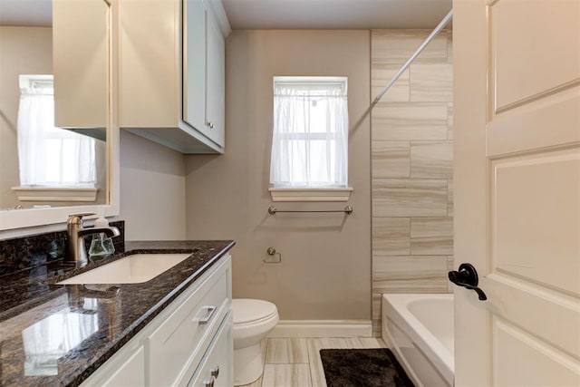 3024 Drake Crest Dr, Edmond, OK 73034 - bathroom with vanity, baseboards, toilet, and washtub / shower combination