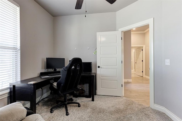 3024 Drake Crest Dr, Edmond, OK 73034 - home office with ceiling fan, baseboards, light carpet, and light wood-type flooring