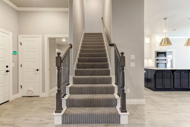 3024 Drake Crest Dr, Edmond, OK 73034 - staircase with wood finished floors, crown molding, and baseboards