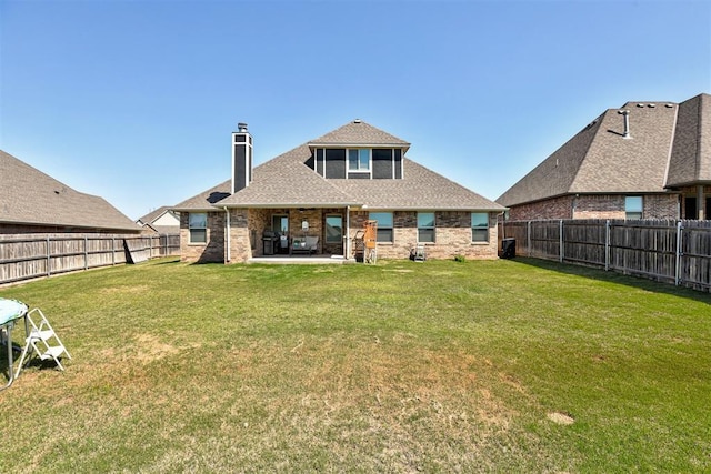 3024 Drake Crest Dr, Edmond, OK 73034 - back of house with a chimney, a patio, brick siding, and roof with shingles
