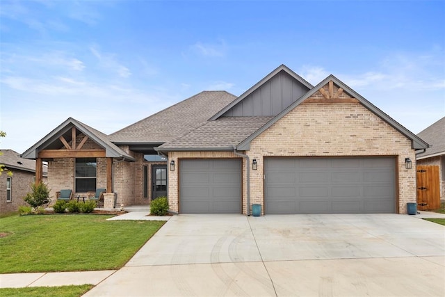 4705 Bermuda Dr, Mustang, OK 73064 - view of front of property with board and batten siding, an attached garage, brick siding, and concrete driveway