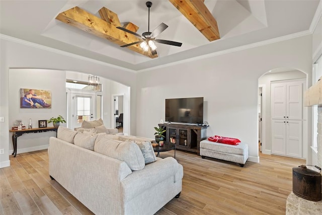 4705 Bermuda Dr, Mustang, OK 73064 - living room with arched walkways, a raised ceiling, light wood-style floors, and crown molding