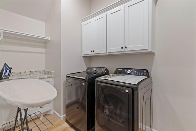4705 Bermuda Dr, Mustang, OK 73064 - laundry area featuring cabinet space, separate washer and dryer, light wood finished floors, and baseboards