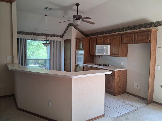 824 SE 38th St, Moore, OK 73129 - kitchen with white appliances, lofted ceiling, ceiling fan, light countertops, and hanging light fixtures
