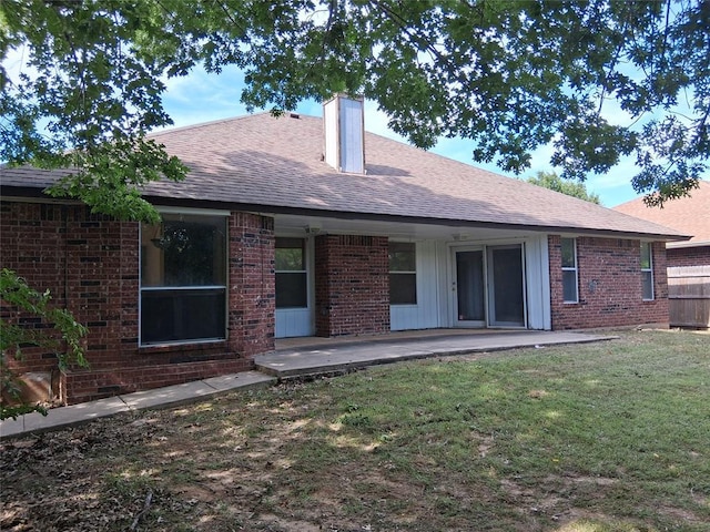 824 SE 38th St, Moore, OK 73129 - rear view of house with brick siding, roof with shingles, and a chimney