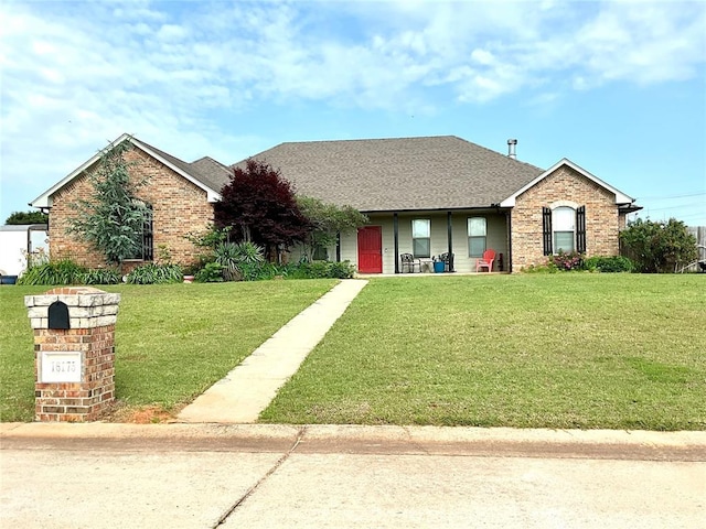 16175 Silver Run Dr, Choctaw, OK 73020 - view of front of house with a front yard, brick siding, roof with shingles, and covered porch
