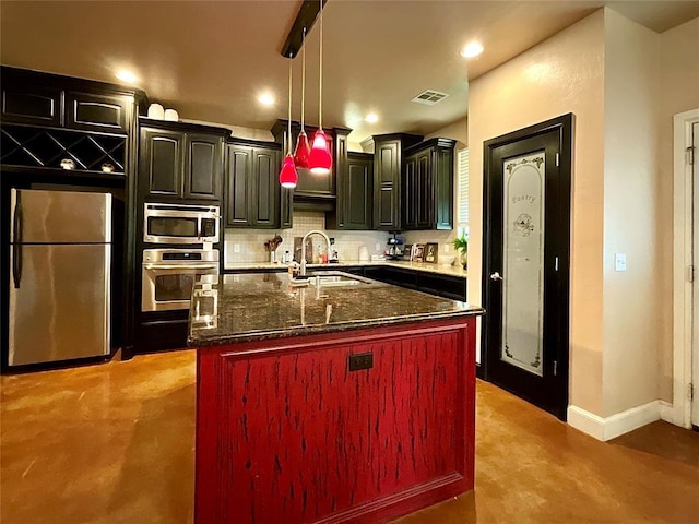 16175 Silver Run Dr, Choctaw, OK 73020 - kitchen featuring appliances with stainless steel finishes, a sink, decorative backsplash, baseboards, and dark stone countertops