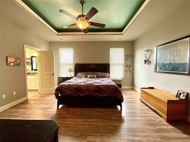 16175 Silver Run Dr, Choctaw, OK 73020 - bedroom with a raised ceiling, wood finished floors, connected bathroom, and baseboards