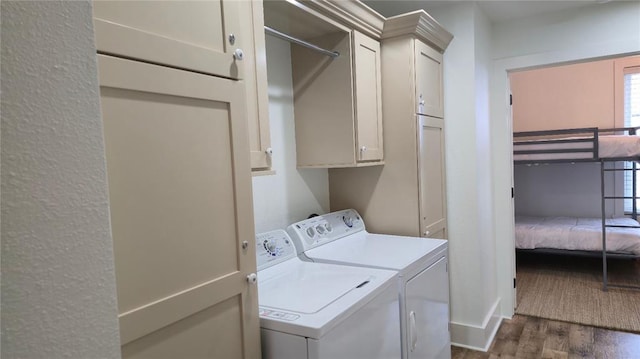 25 Firefly Ln, Eufaula, OK 74432 - laundry room with washer and clothes dryer, cabinet space, dark wood-style floors, and healthy amount of natural light