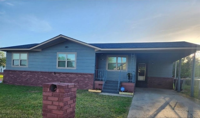 2421 N Prospect Ave, Oklahoma City, OK 73111 - ranch-style house with brick siding, a front lawn, concrete driveway, an attached carport, and a shingled roof