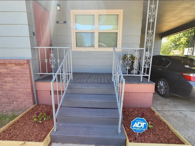 2421 N Prospect Ave, Oklahoma City, OK 73111 - view of exterior entry with a porch and an attached carport