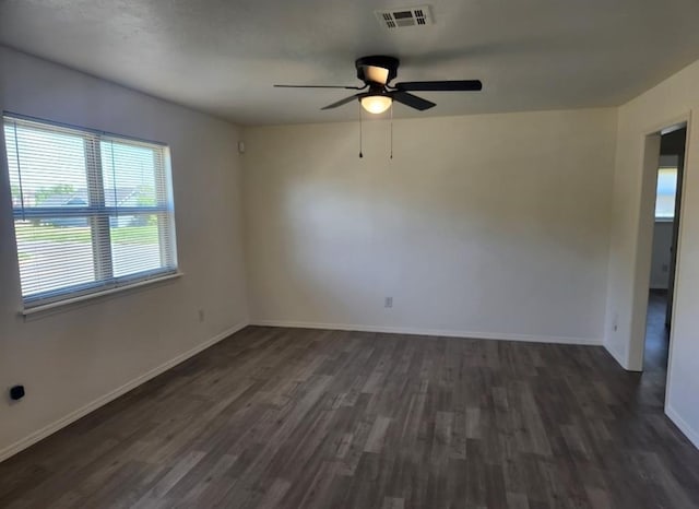 2421 N Prospect Ave, Oklahoma City, OK 73111 - unfurnished room featuring dark wood finished floors, ceiling fan, and baseboards