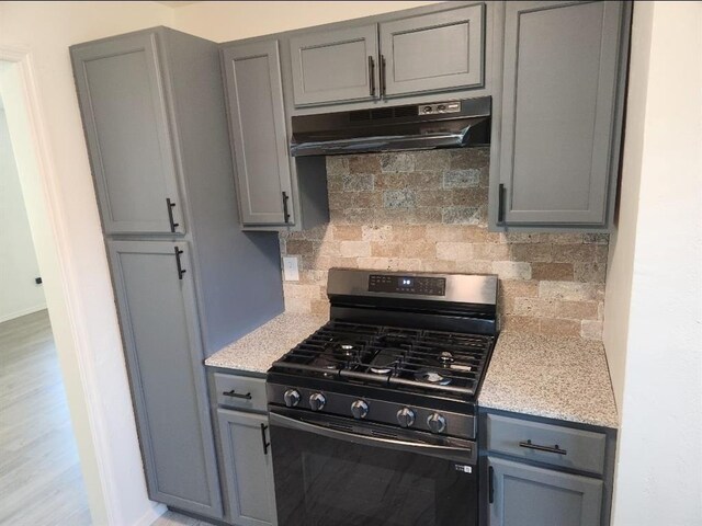2421 N Prospect Ave, Oklahoma City, OK 73111 - kitchen featuring black range with gas cooktop, under cabinet range hood, and gray cabinetry