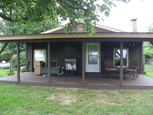 218 N 4150th Rd, Antlers, OK 74523 - rear view of property featuring a wooden deck, a chimney, and a yard